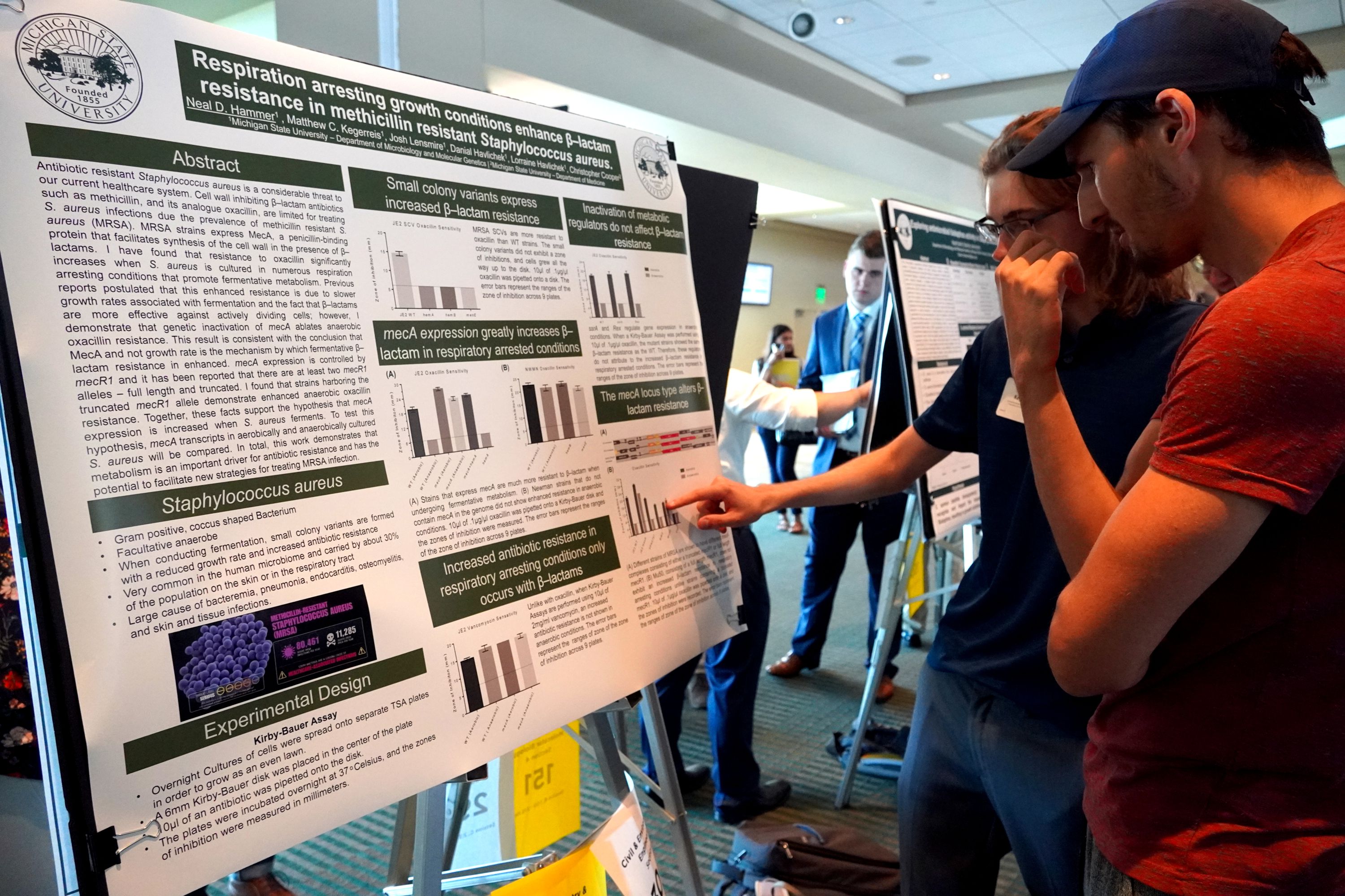 Students reading a research poster.