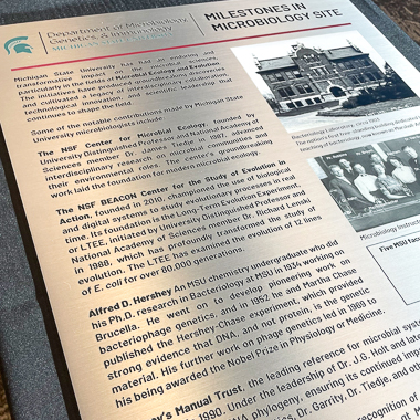 The milestones plaque is displayed during the celebration. It is a large metal plaque with text and two images. 